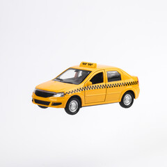 Miniature of yellow taxi car isolated on white background