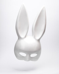 Plastic bunny mask levitating on white background with shadow. Minimal concept