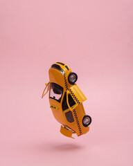 Levitating, hovering in antigravity model of taxi car with open doors and trunk on pink background
