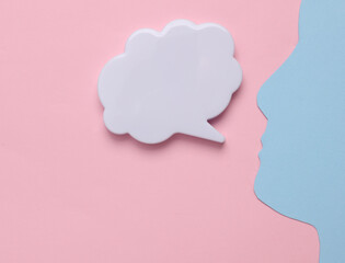 Speech bubble with head silhouette on pink background
