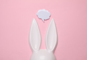 Bunny ears sex shop mask with speech ball on pink background