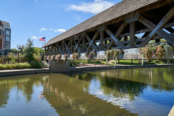 Fototapeta premium Scenic View of Covered Bridge Downtown Naperville Riverwalk, Crown Jewel of Naperville in downtown Naperville Illinois