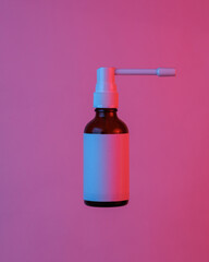 Throat spray bottle floating in the air, isolated in blue-red neon gradient light. Levitating objects. Minimal concept