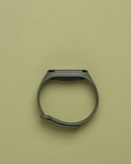 Smart watch on a green background. Minimal photo. Modern gadget. Top view