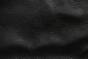 Texture of wavy black leather surface closeup