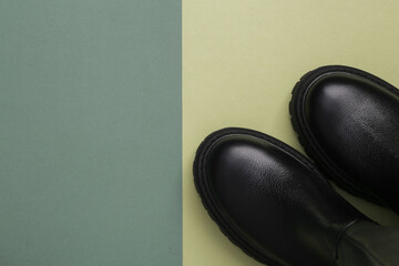 Leather high women's boots on a green background. Top view