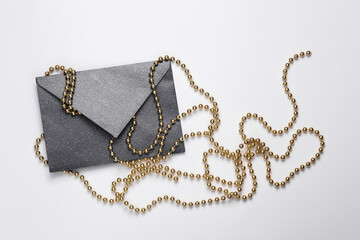 Black envelope with a garland on a white background