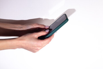 Woman's hand using smartphone on white background