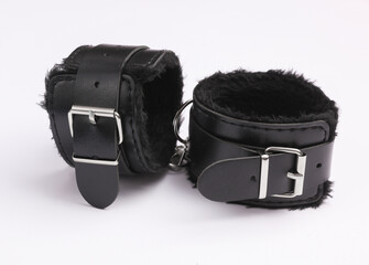 Leather handcuffs from sex shop on white background