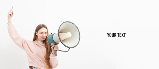 Caucasian young woman student speaks into a bullhorn (loudspeaker) on white background. Reporting important information