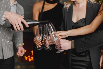 Midsection people holding a glasses with champagne while celebrating New Year