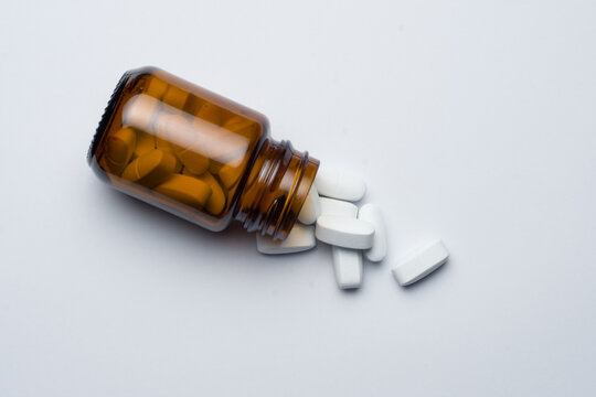 Medicine Pill Tablet With Spilled Bottle, White Background