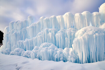 Snow fort made of ice and icicles on a winter wonder day - obrazy, fototapety, plakaty