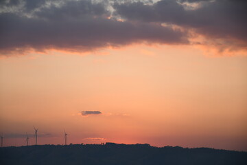 sunrise in mountains with windmill