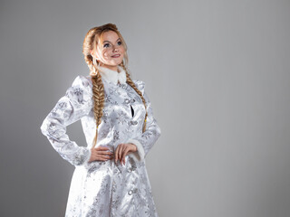 Snow maiden, a beautiful young woman in a fabulous fur coat of silver color, a character in a winter Christmas or New Year fairy tale.