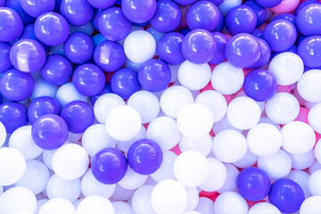 collection of purple and white balls in a boz