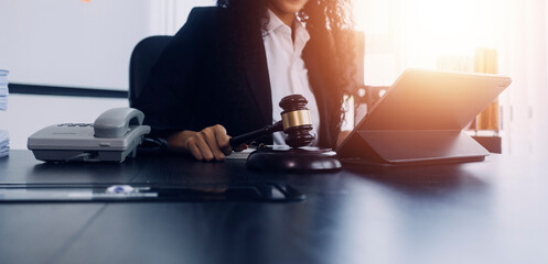 justice and law concept.Male judge in a courtroom on wooden table and Counselor or Male lawyer working in office. Legal law, advice and justice concept.