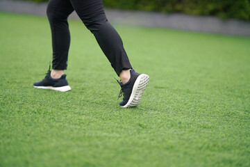 woman ,runner run with shoe on lawn grass