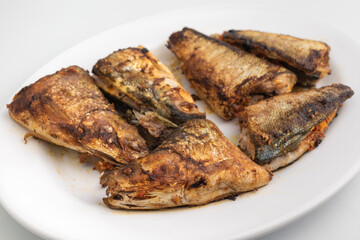 grilled milkfish or Ikan Bandeng Bakar on white plate isolated on white background