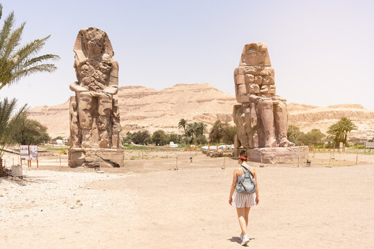 Woman Walking Towards An Ancient Egyptian Statues