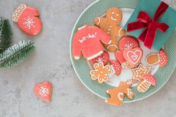 Festive composition of Christmas gingerbread cookies, fir branches. Flat lay, top view. Copy space. Holiday Season.