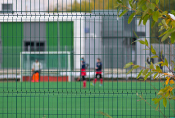 Metal fencing of the stadium on an autumn day