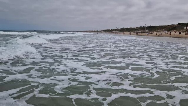 movement of the waves on the beach of La Barrosa in Sancti Petri, Cadiz