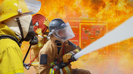 Fireman,Firefighter training Firefighters using water and fire extinguishers to fight the flames in emergency situations. in a dangerous situation All firefighters wear firefighter uniforms for safety