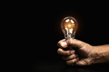 Close up hand choose light bulb or lamp with bright light for human resources or leadership and creativity thinking idea motivation or vision and knowledge learning and study or education concept.