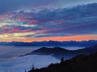 Fog on the plain of Friuli and view of the Alps at sunset from Mount Bernadia in Tarcento