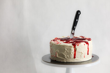designer chef decorating white red bloody horror crime cake for halloween party
