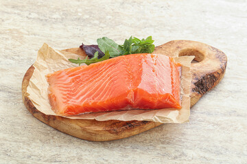 Raw salmon fillet over board