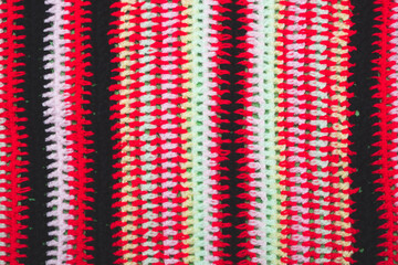 Knitted background from colored threads close up