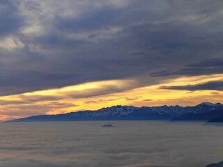 Fog on the plain of Friuli and view of Piancavallo and Mount Ragogna at sunset from Mount Bernadia in Tarcento