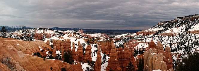 Bryce canyon panorama in overcast winter day with orange rocks and snow