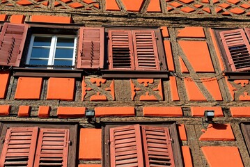 Facade of fachwerkhaus, or timber framing, in Riquewihr village, Alsace, France