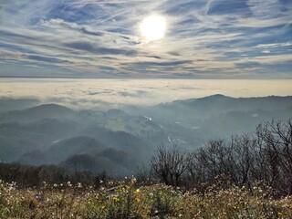 Tarcento and the fog on plain of Friuli seen from Mount Bernadia on a cloudy day