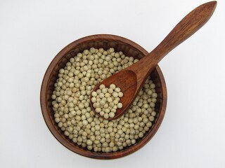 White peppers in a wooden bowl 