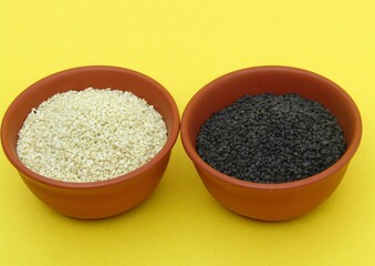 White and black Sesame seeds in bowls 