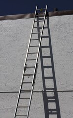 Tall Ladder Leaning Against Wall with Dark Shadow © Bill McKeon