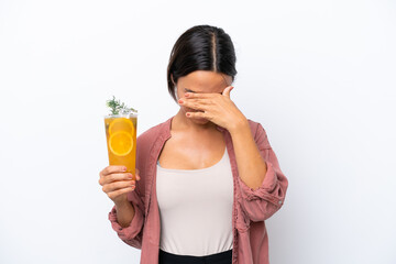 Young hispanic woman holding a cocktail isolated on white background with tired and sick expression