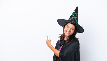 Young hispanic woman dressed as witch over isolated background pointing back