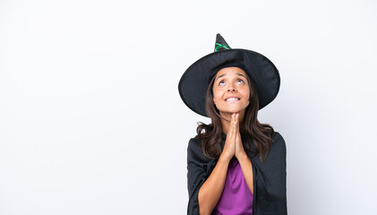 Young hispanic woman dressed as witch over isolated background keeps palm together. Person asks for something