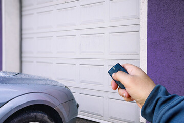 Garage door PVC. Hand use remote controller for closing and opening garage door 