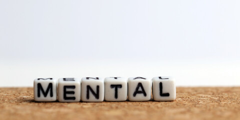 Closeup of word on plastic cube on wooden desk background concept - dental