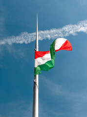 The flag of Hungary on a tall metal pole.