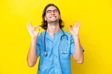 Young surgeon caucasian man isolated on yellow background in zen pose