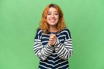 Young caucasian woman isolated on green screen chroma key background laughing