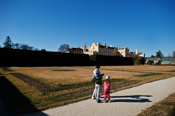 Obraz premium Three kids walking at Lednice park, Czech Republic.