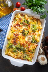 Pasta baked with broccoli and chicken. Broccoli, cheese and gratin sauce on baked penne pasta.